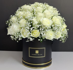 white roses in black box